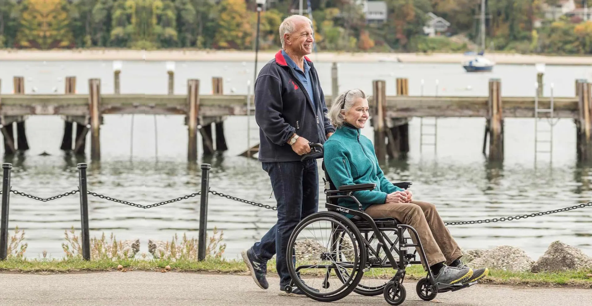 Happy senior enjoying wheelchair freedom in Denver Colorado park